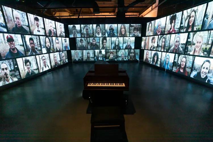 On a Human Scale — a playable grand piano ringed by video portraits of singers
